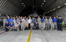 U.S. Air Force Airmen assigned to the 8th Aircraft Maintenance Squadron and Korean War veterans and their families pose for a photo June 30, 2017, during a tour at Kunsan Air Base, Republic of Korea. Members of the Korean War Veterans Association, which is comprised of veterans and their families, received the tour as a sign of thanks for the sacrifices they endured in order to make the Wolf Pack what it is today. (U.S. Air Force photo by Staff Sgt. Victoria H. Taylor/Released) (U.S. Air Force photo by Staff Sgt. Victoria H. Taylor/Released)