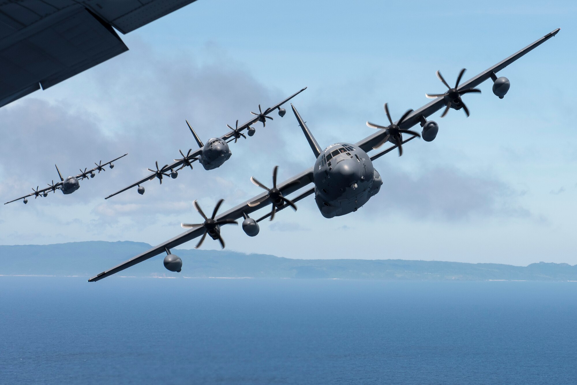 U.S. Air Force MC-130J Commando IIs from the 17th Special Operations Squadron line up in a five-aircraft formation June 22, 2017 off the coast of Okinawa, Japan, during a mass launch training mission. Routine flights and airdrops are conducted to maintain proficiency and training certifications for prospective missions. (U.S. Air Force photo by Senior Airman John Linzmeier)