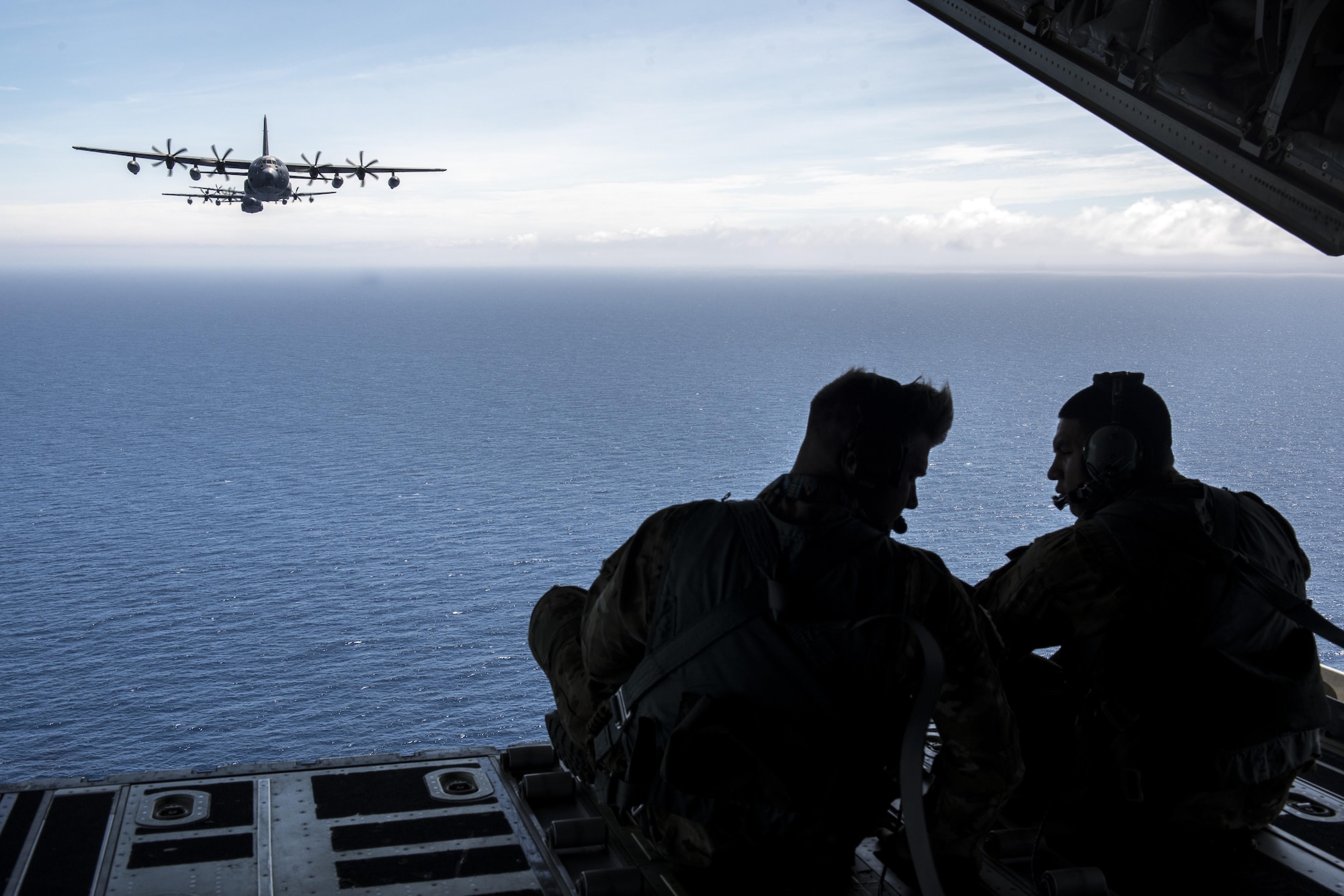 U.S. Air Force loadmaster Airmen, from the 17th Special Operations Squadron, overserve a five-aircraft formation comprised of MC-130J Commando IIs June 22, 2017 off the coast of Okinawa, Japan, during a mass launch training mission. Airmen from the 17th SOS conduct training operations often to ensure they are always ready perform a variety of high-priority, low-visibility missions throughout the Indo-Asia-Pacific-Region. (U.S. Air Force photo by Senior Airman John Linzmeier)