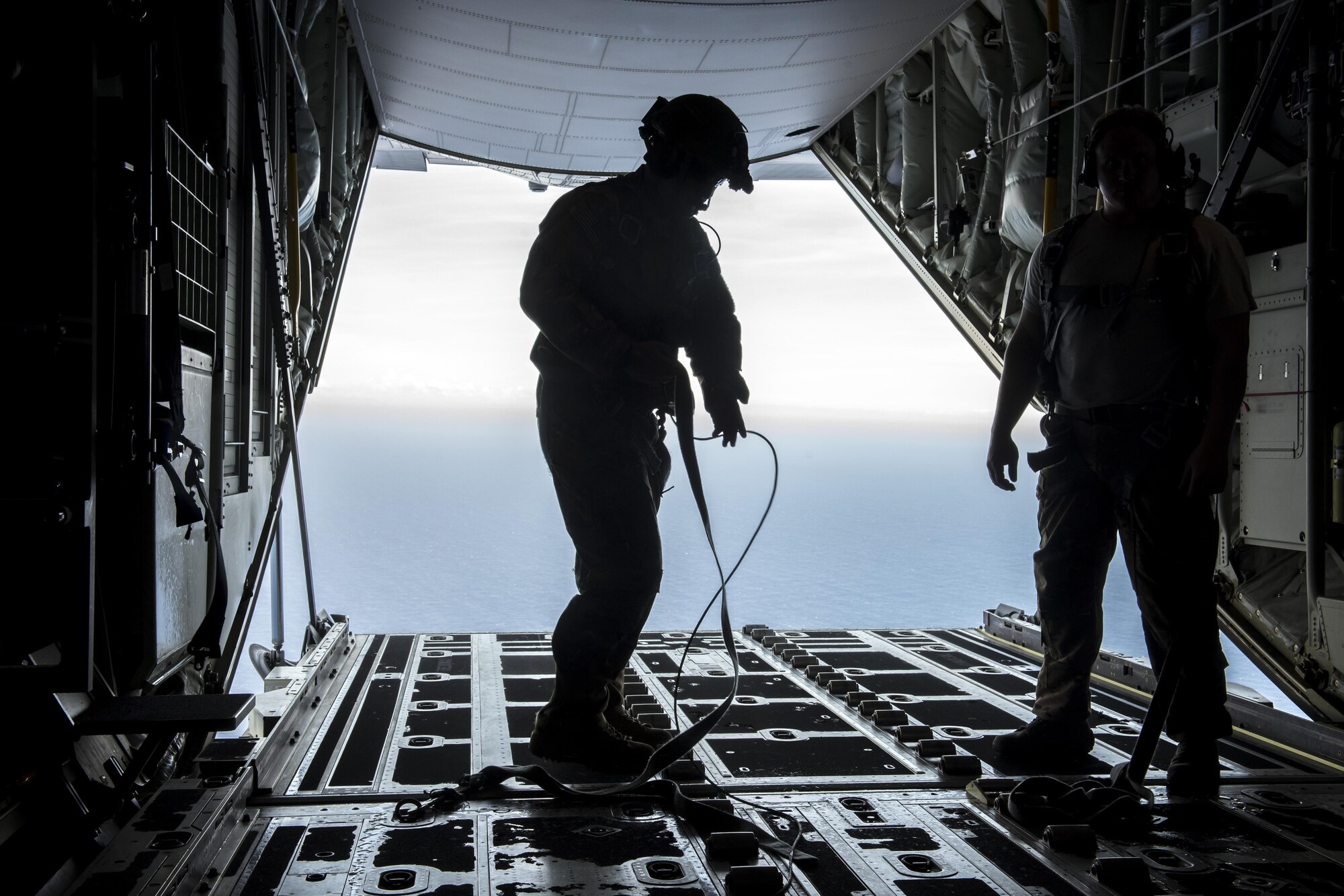 A U.S. Air Force MC-130J Commando II loadmaster from the 17th Special Operations Squadron adjusts his safety harness during a mass launch training mission June 22, 2017, off the coast of Okinawa, Japan. The MC-130J was among four others that flew in formation and completed airdrop training on Ie Shima, Okinawa. (U.S. Air Force photo by Senior Airman John Linzmeier)