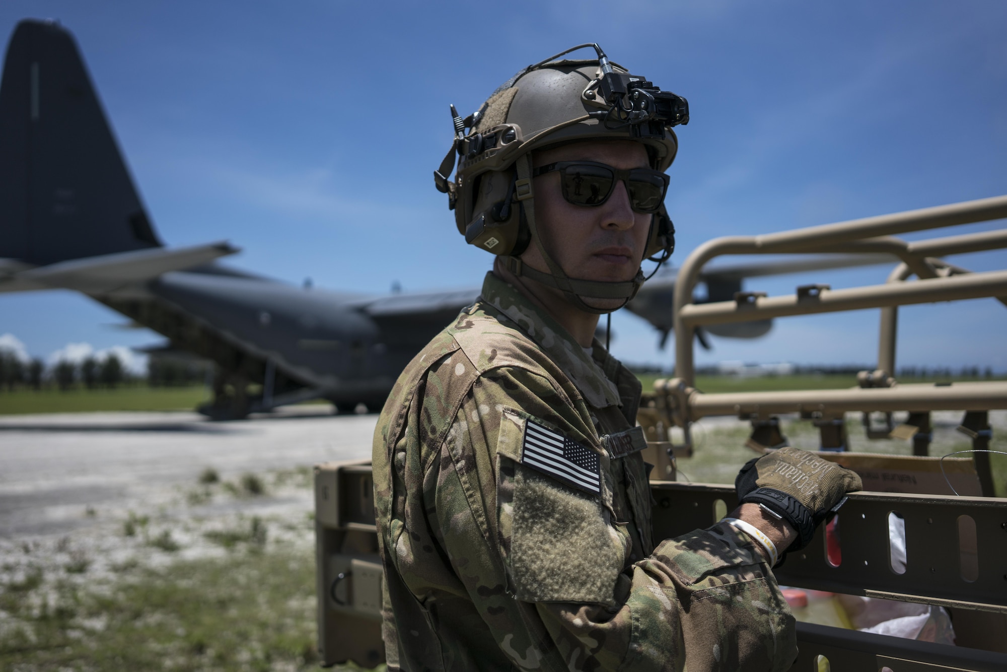 A U.S. Air Force MC-130J Commando II loadmaster assigned to the 17th Special Operations Squadron stands postured to support the rapid infiltration and exfiltration of a tactical vehicle during a mass launch training mission June 22, 2017, at Ie Shima Range, Okinawa, Japan. Airmen from the 17th SOS conduct training operations often to ensure they are always ready perform a variety of high-priority, low-visibility missions throughout the Indo-Asia-Pacific-Region. (U.S. Air Force photo by Capt. Jessica Tait)