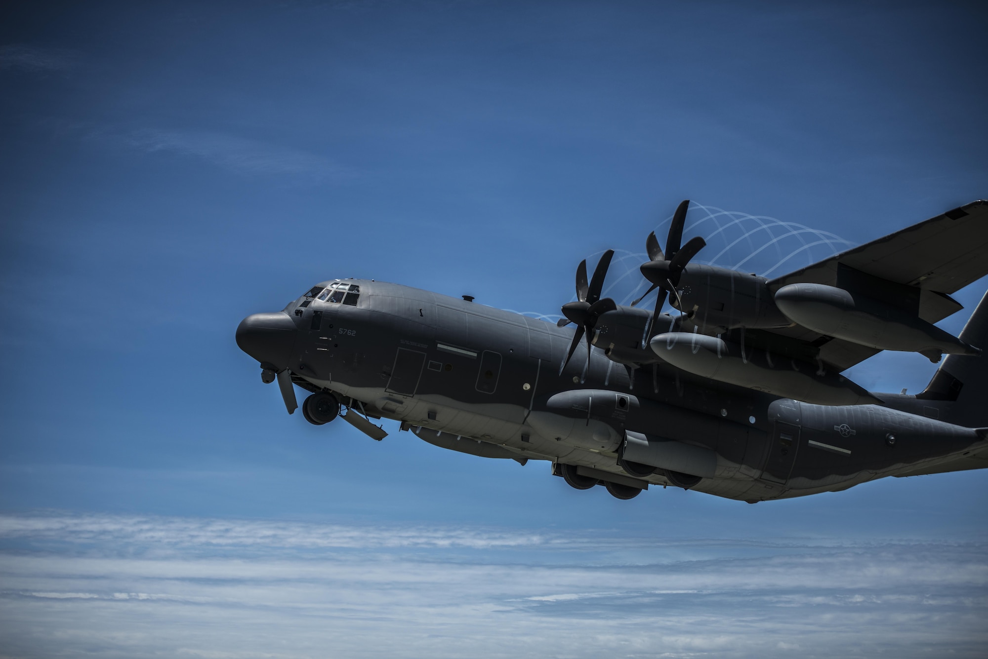 A U.S. Air Force MC-130J Commando II flies during a mass launch training mission June 22, 2017, at Ie Shima Range, Okinawa, Japan. Routine flights and airdrops are conducted to maintain proficiency and training certifications for prospective missions. (U.S. Air Force photo by Capt. Jessica Tait)