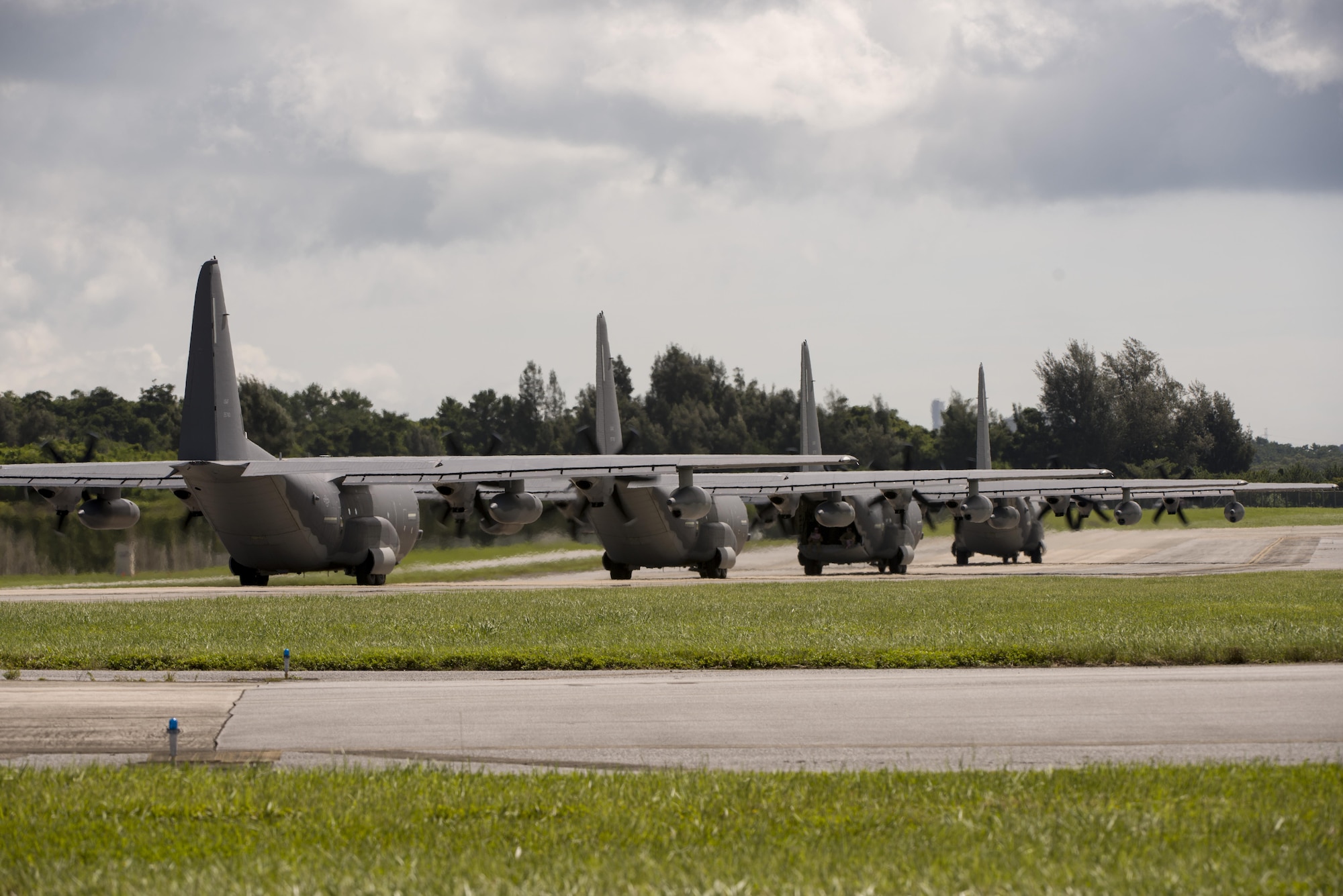 U.S. Air Force MC-130J Commando IIs from the 17th Special Operations Squadron taxi on the flight line in a four-aircraft formation take off during a mass launch training mission June 22, 2017 at Kadena Air Base, Japan. Airmen from the 17th SOS conduct training operations often to ensure constant readiness to perform a variety of high-priority, low-visibility missions throughout the Indo-Asia Pacific Region. (U.S. Air Force photo by Senior Airman Omari Bernard)