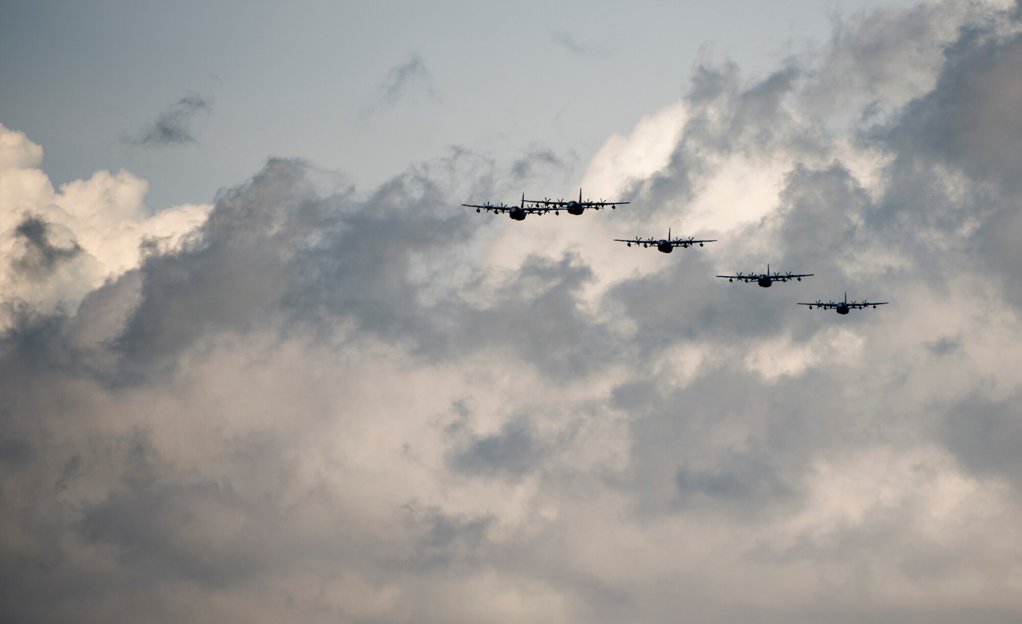 U.S. Air Force MC-130J Commando IIs from the 17th Special Operations Squadron return to base in a five-aircraft formation during a mass launch training mission June 22, 2017 at Kadena Air Base, Japan. Airmen from the 17th SOS conduct training operations often to ensure constant readiness to perform a variety of high-priority, low-visibility missions throughout the Indo-Asia Pacific Region. (U.S. Air Force photo by Senior Airman Omari Bernard)