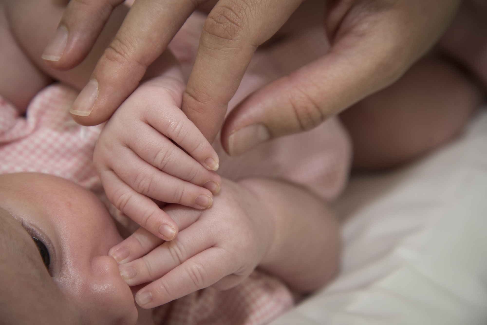 Aaliyah Murdock, left, daughter of U.S. Air Force Airman 1st Class Monet Murdock, right, a 35th Logistics Readiness Squadron customer service technician, holds her mother’s finger at Misawa Air Base, Japan, June 29, 2017. Obstetrics and gynecologist physicians provide help in family planning when service members and their spouses decide to have children. (U.S. Air Force photo by Airman 1st Class Sadie Colbert)