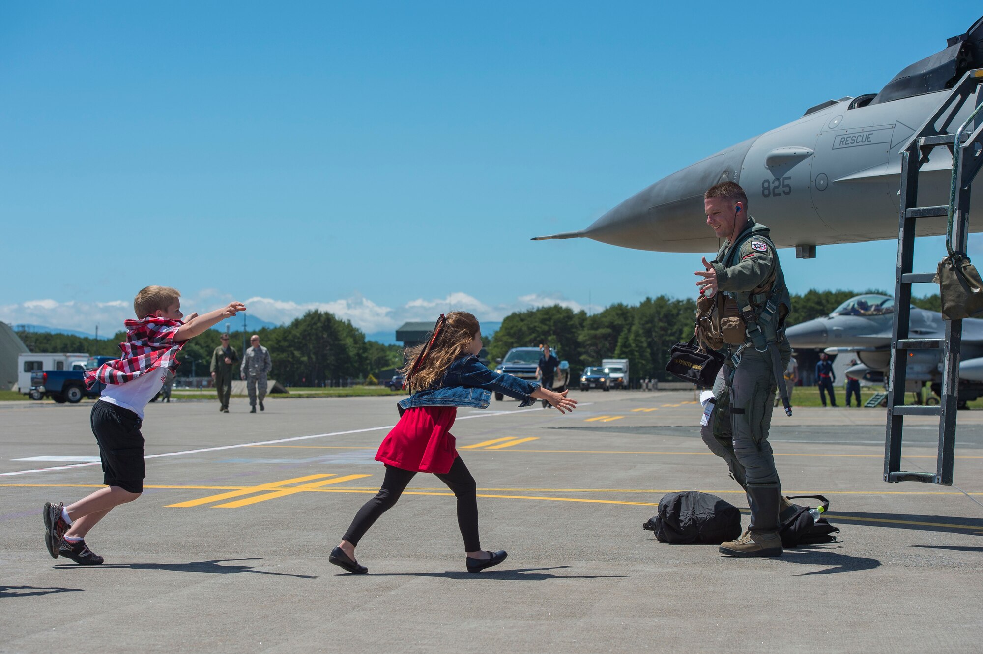 U.S Air Force Lt. Col. Christopher Moeller, 13th Fighter Squadron commander, children run to greet him after returning home from a temporary duty location at Misawa Air Base, Japan, June 26, 2017. Moeller and his team of 13th FS pilots returned from Kunsan Air Base, Republic of Korea, to a newly refurbished airfield executed by the 35th Civil Engineer Squadron and their host nation counterparts. (U.S. Air Force photo by Senior Airman Deana Heitzman)