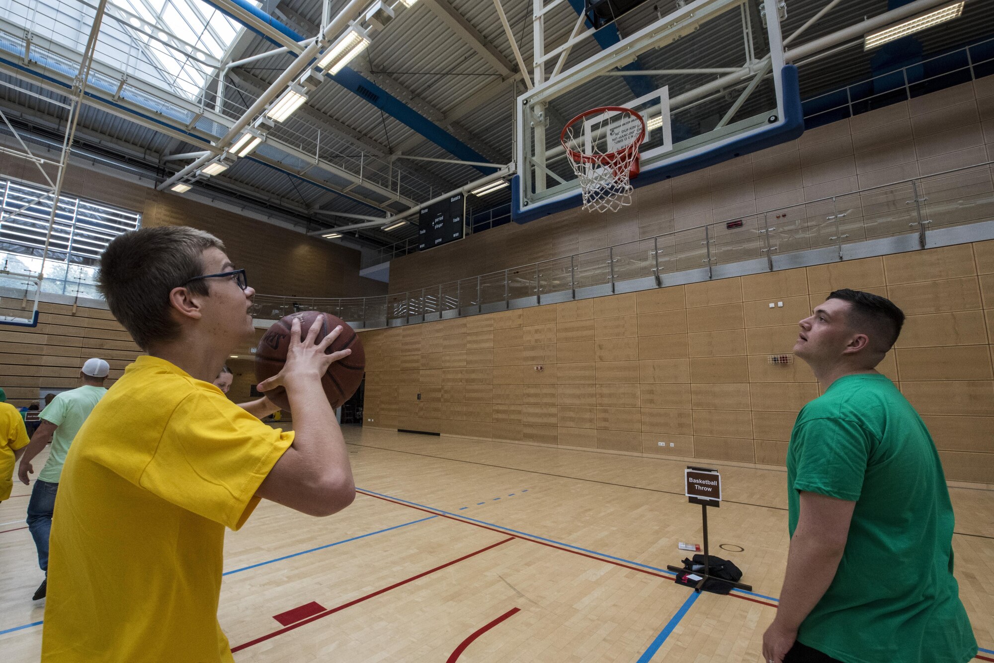 A student prepares to shoot a basketball during the St. Martins Special Children's Day at Spangdahlem Air Base, Germany, June 28, 2017. St. Martins School and Spangdahlem students paired up with volunteers to engage in activities that were meant to be both challenging and fun. (U.S. Air Force photo by Senior Airman Preston Cherry)