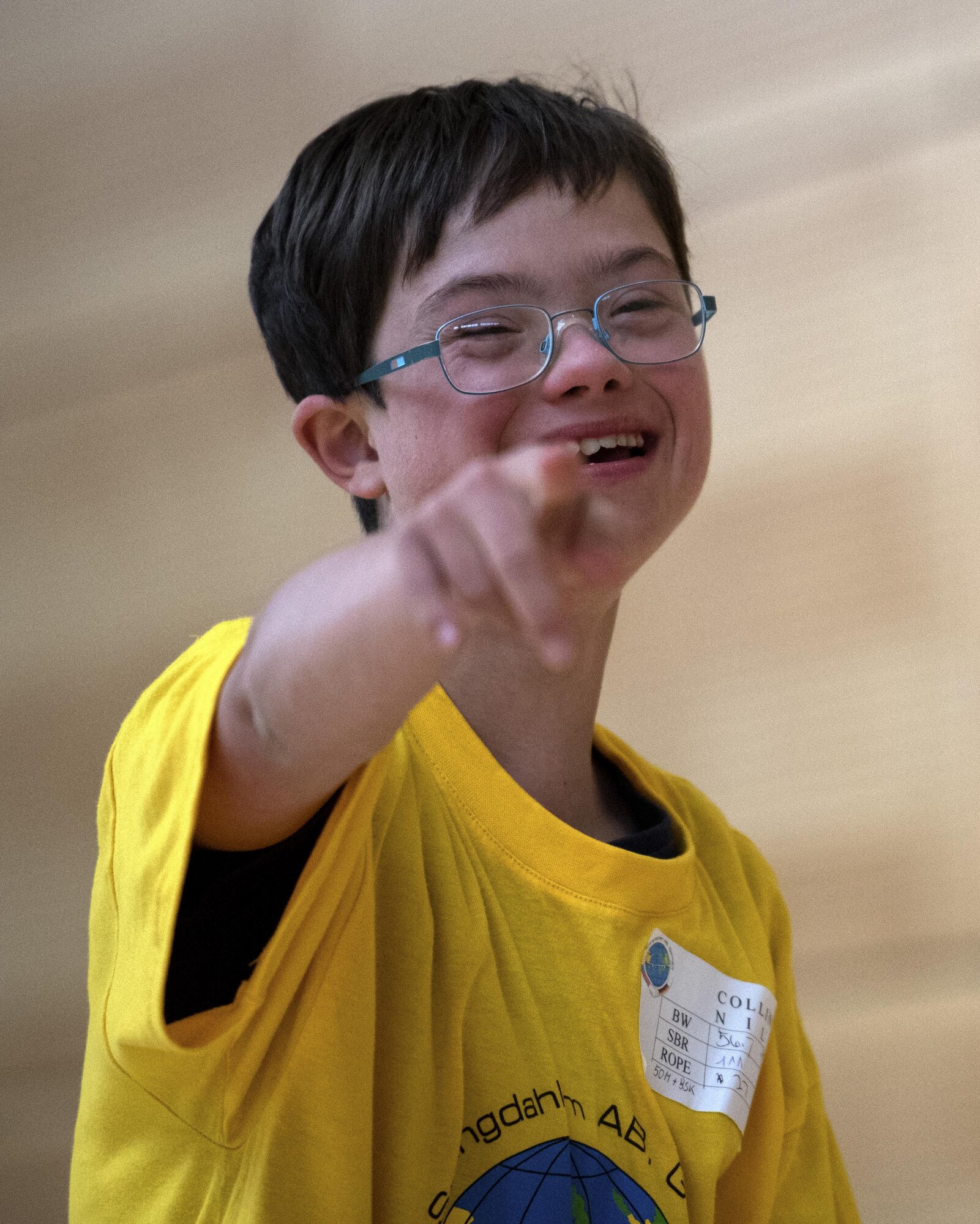 Nils Collins, student from St. Martins School in Bitburg, laughs during the St. Martin Special Children's Day at Spangdahlem Air Base, Germany, June 28, 2017. Each student from the event was paired up with a volunteer to participate in a variety of activities including basketball throw, hula-hooping, balance beam and bowling. (U.S. Air Force photo by Senior Airman Preston Cherry)