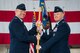 U.S. Air Force Col. Joseph McFall, 52nd Fighter Wing commander, left, gives the ceremonial guidon to U.S. Air Force Col. Edward LaGrou, incoming 52nd Medical Group commander, right, during the 52nd MDG change of command ceremony at Spangdahlem Air Base, Germany, June 29, 2017. (U.S. Air Force photo by Senior Airman Preston Cherry)