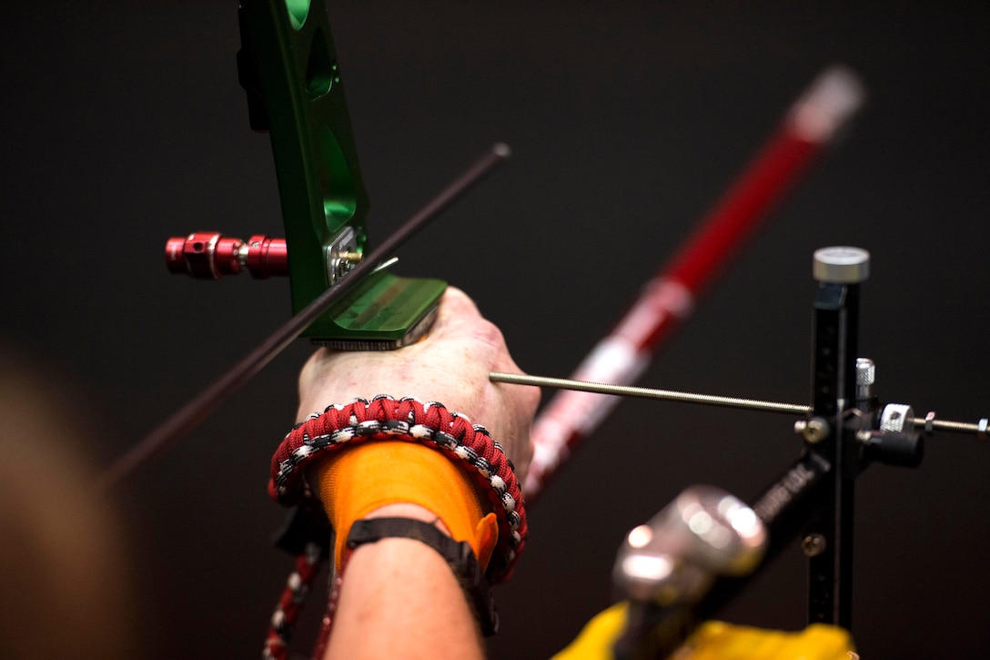 A metal rod serves as a guide to help a visually impaired archer find his mark during practice for the 2017 Department of Defense Warrior Games in Chicago, June 29, 2017. DoD photo by EJ Hersom