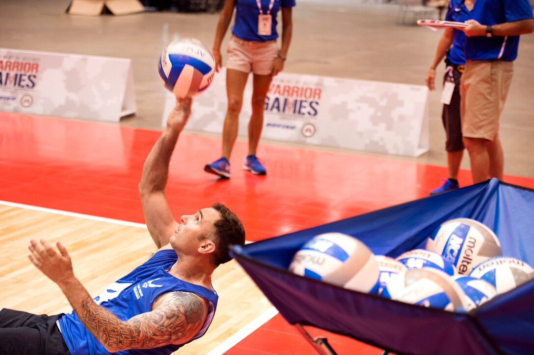 Air Force Tech Sgt. Christopher D’Angelo returns a ball during sitting volleyball practice for the 2017 Department of Defense Warrior Games in Chicago, June 29, 2017. DoD photo by EJ Hersom 