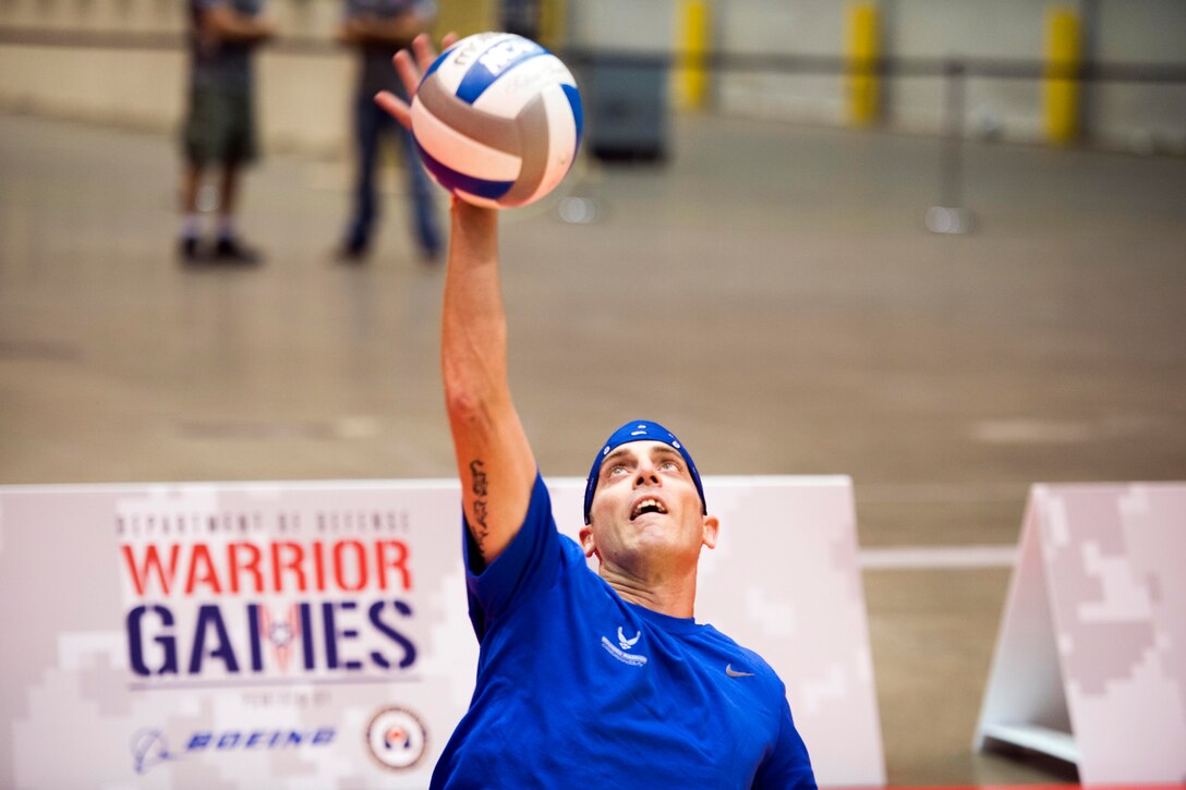 Air Force Special Agent Bill Lickman serves a ball during sitting volleyball practice for the 2017 Department of Defense Warrior Games in Chicago, June 29, 2017. DoD photo by EJ Hersom