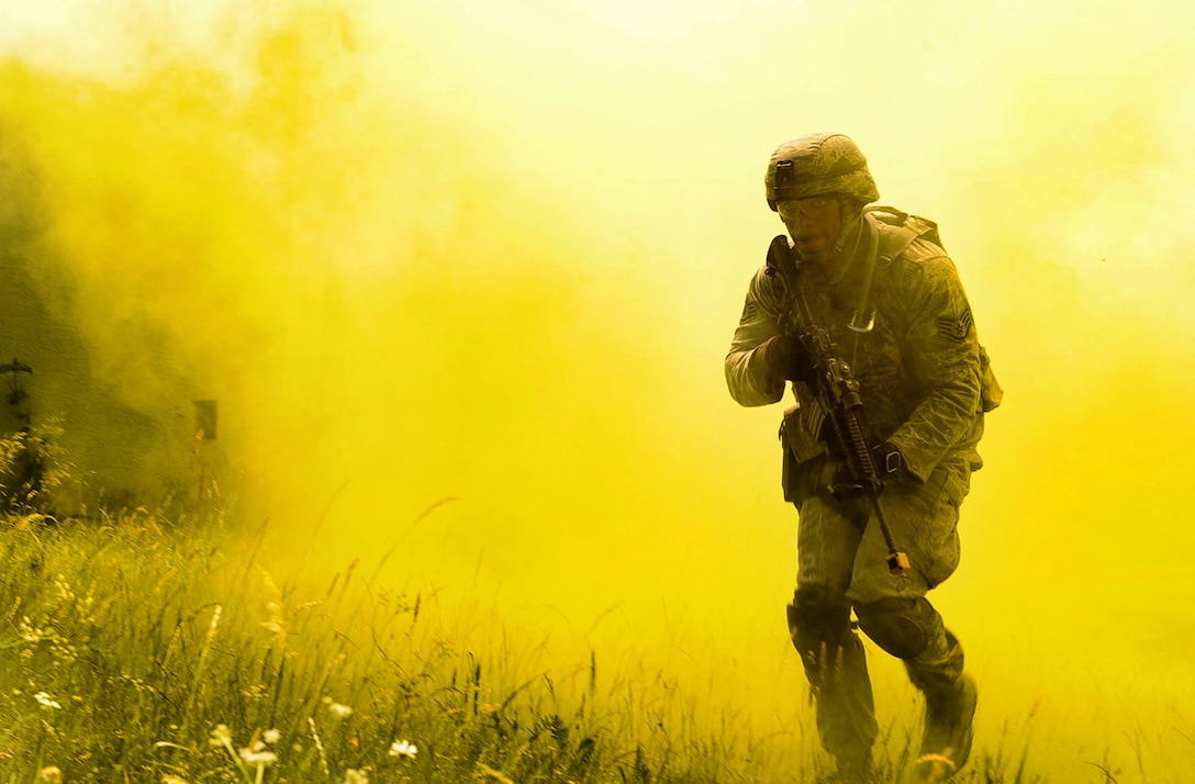 Staff Sgt. Eric Jeffcoat, a 100th Security Forces Squadron base defense operation center controller, emerges from smoke grenade smoke during the 435th SFS’s Ground Combat Readiness Training Center Security Operations Course at U.S. Army Garrison Baumholder, Germany, June 15, 2017. Conducting missions as a team and being evaluated by the 435th SFS instructor cadre, students showcased knowledge of urban operations, close quarters combat, live firing iterations, mounted and dismounted patrols, entry control point operations, and counter improved-explosive device operations while at Baumholder. (U.S. Air Force photo/Airman 1st Class Savannah L. Waters)