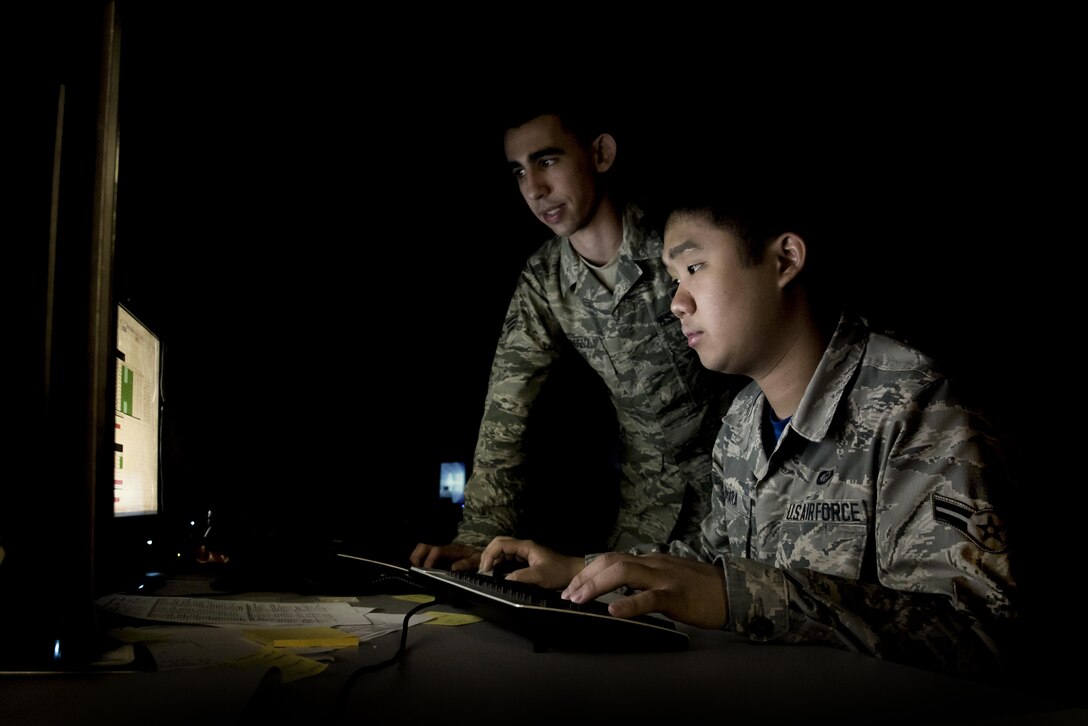 Senior Airman Joseph Goebel, left, and Airman 1st Class Anthony Ohara, both 35th Operations Support Squadron weather forecasters, analyze climate patterns during Red Flag-Alaska 17-2 at Eielson Air Force Base, Alaska, June 16, 2017. Goebel and Ohara were in charge of running the weather flight for RF-A, which consisted of seven other Air National Guardsman from Joint Base Lewis-McChord, Wash. (U.S. Air Force photo/Airman 1st Class Sadie Colbert)