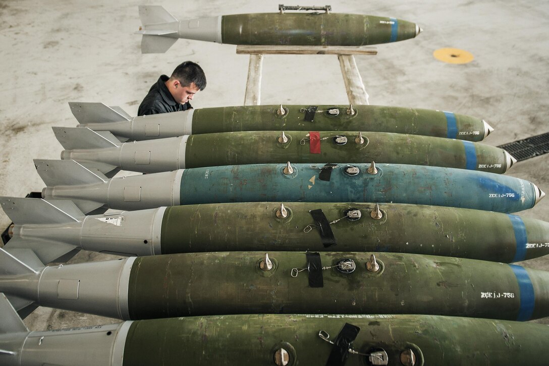 Senior Airman Matise Venett, a 5th Aircraft Maintenance Squadron weapons load crew member, inspects munitions before they are loaded into a B-52H Stratofortress at Minot Air Force Base, N.D., June 19, 2017. The training munitions were loaded into an aircraft by the 5th AMXS Global Strike Challenge team during their bomb-loading competition. (U.S. Air Force photo/Senior Airman J.T. Armstrong)