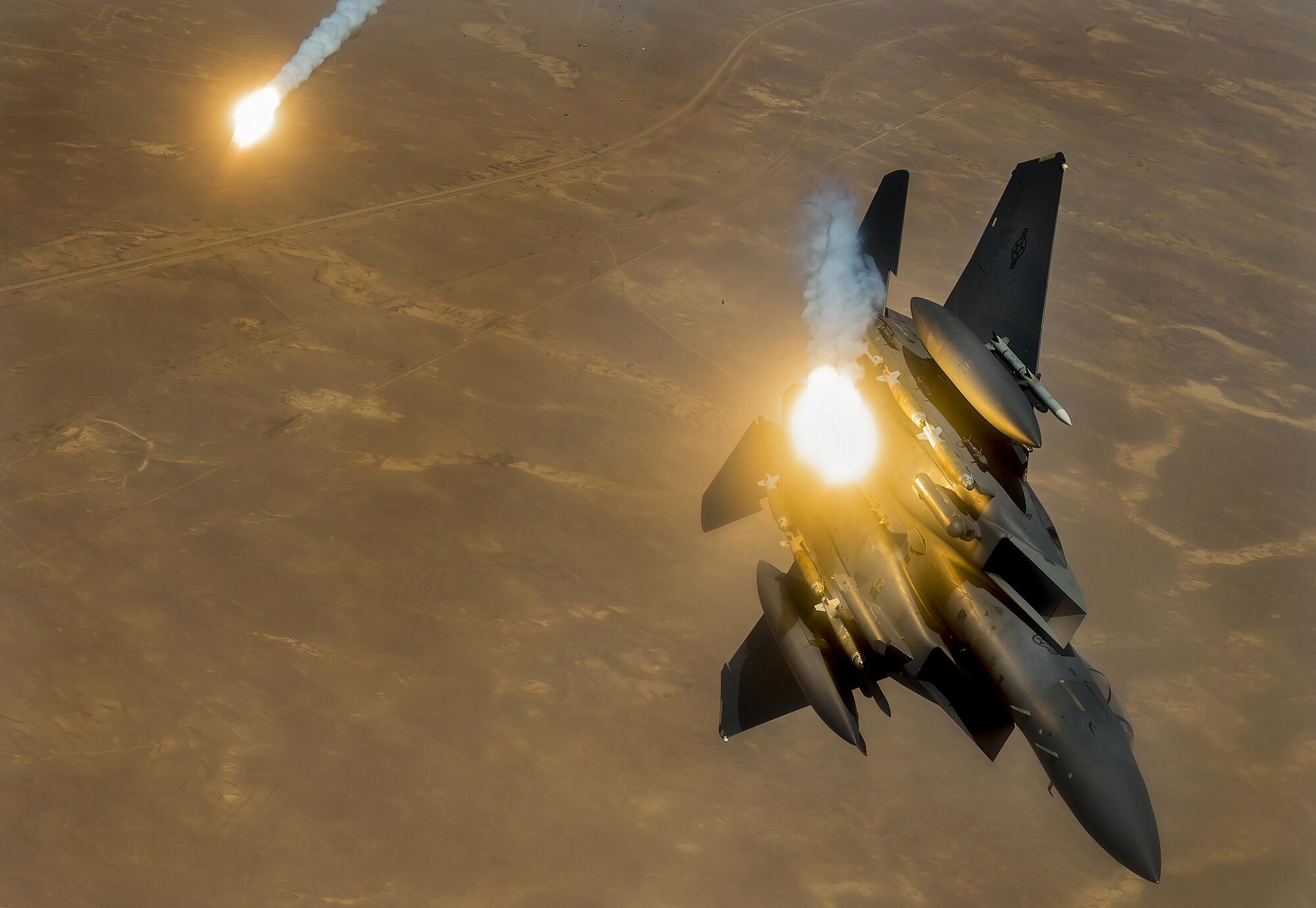 An F-15E Strike Eagle fires flares during a flight in support of Operation Inherent Resolve June 21, 2017. The F-15E, a component of U.S. Air Forces Central Command, supports U.S. and coalition forces working to liberate territory and people under the control of the Islamic State of Iraq and Syria. (U.S. Air Force photo/Staff Sgt. Trevor T. McBride)