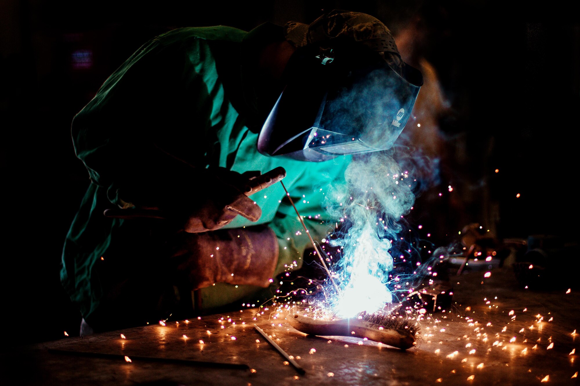 Airman 1st Class Hogan Lambeth, an 11th Civil Engineer Squadron structural apprentice, welds a metal rod at Joint Base Andrews, Md., June 21, 2017. As a metals structural technician, Lambeth is called on to complete welding, sheet metal, duct work, fabrication and repairs to maintain equipment and facilities throughout the base. (U.S. Air Force photo/Senior Airman Delano Scott)