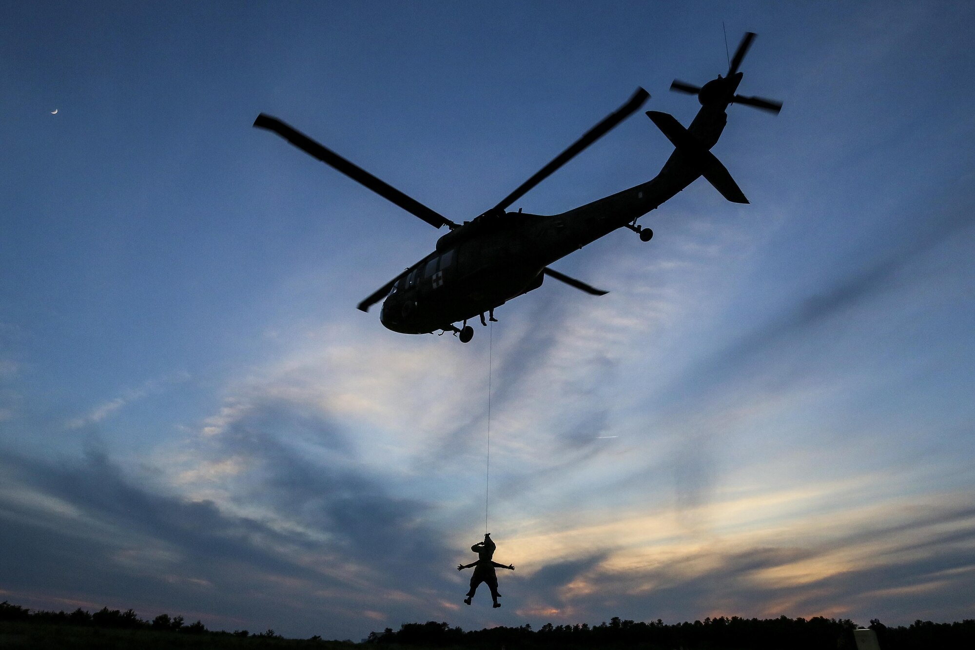 Tactical control party Airmen from the 227th Air Support Operations Squadron descend from a 1-150th Assault Helicopter Battalion UH-60 Black Hawk helicopter during joint training for New Jersey Task Force One at Joint Base McGuire-Dix-Lakehurst, N.J., June 28, 2017. The primary mission of New Jersey Task Force One is to provide advanced technical search and rescue capabilities to victims trapped or entombed in structurally collapsed buildings. Task Force One is made up of New Jersey National Guard Soldiers and Airmen, as well as civilians. (U.S. Air National Guard photo/Master Sgt. Matt Hecht)