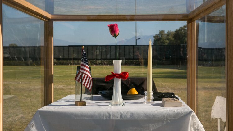 The Prisoner of War/Missing in Action table represents the service members who never had a chance to make it home or could not be found at the opening program of the Moving Vietnam Veterans Memorial Wall at Mission Springs Park in Desert Hot Springs, Calif., June 22, 2017. The Moving Wall, a scale model of the original Vietnam Veterans Memorial Wall, has the names of those men and women who were killed or missing in action etched onto a reflective stone, so visitors can not only see the names, but see themselves, reflecting on the lives of the people who fought and died to keep them safe. (U.S. Marine Corps photo by Cpl. Dave Flores)