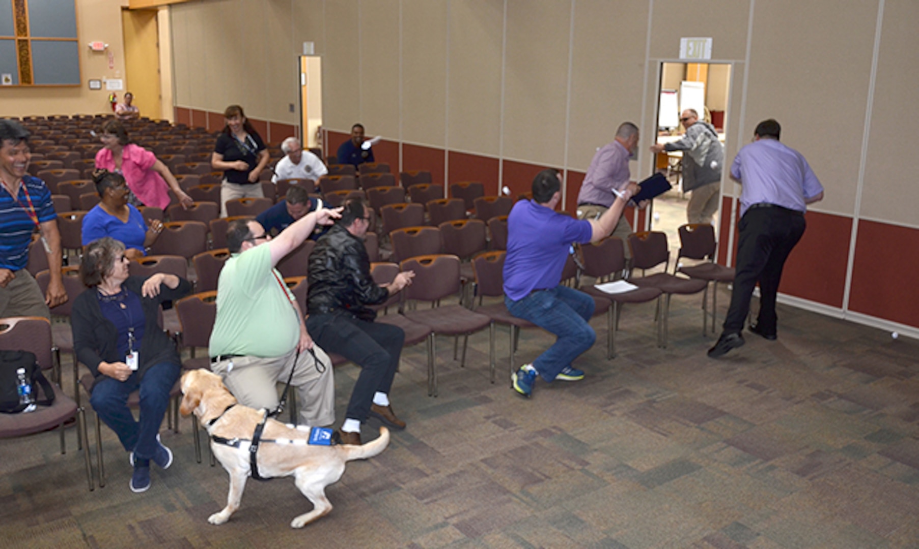Defense Supply Center Richmond employees throw paper at a mock active shooter, then run away to demonstrate how to disrupt and disorient his thought processes during Active Shooter Awareness and Response Training on DSCR in Virginia, June 23, 2017 in the Frank B. Lotts Conference Center. (Photo by Jackie Roberts)