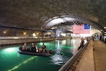 Sailors assigned to Navy Experimental Diving Unit (NEDU) stand by to assist in the David Taylor Model Basin during the 14th International Human-Powered Submarine Races (ISR) at Naval Surface Warfare Center, Carderock Division in West Bethesda, Md., June 28, 2017. NEDU and supporting dive-qualified Sailors in the National Capital Region are helping ensure a safe competition between the students at Carderock racing human-powered submersibles they designed and built for the biennial event, which is sponsored by the Foundation for Underwater Research and Education and is considered the capstone event for science, technology, engineering and mathematics outreach at Carderock.