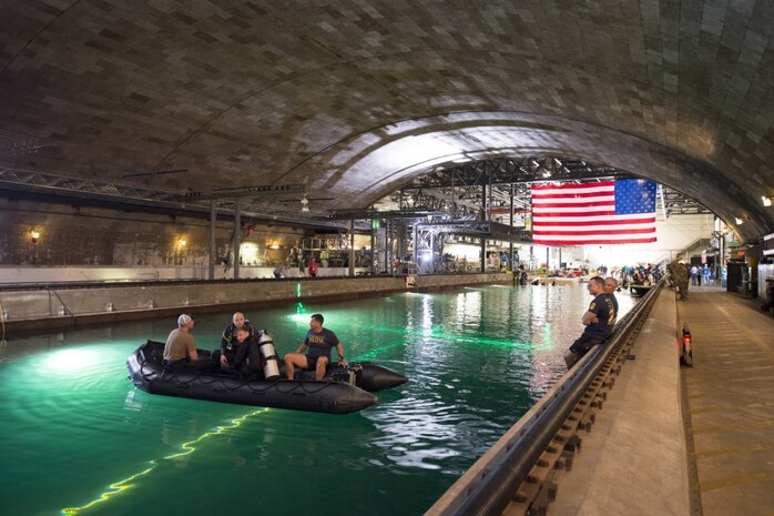 Sailors assigned to Navy Experimental Diving Unit (NEDU) stand by to assist in the David Taylor Model Basin during the 14th International Human-Powered Submarine Races (ISR) at Naval Surface Warfare Center, Carderock Division in West Bethesda, Md., June 28, 2017. NEDU and supporting dive-qualified Sailors in the National Capital Region are helping ensure a safe competition between the students at Carderock racing human-powered submersibles they designed and built for the biennial event, which is sponsored by the Foundation for Underwater Research and Education and is considered the capstone event for science, technology, engineering and mathematics outreach at Carderock.