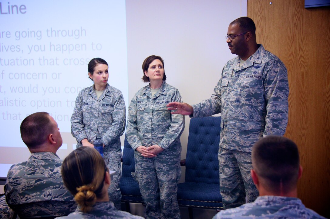 At right, the 932nd Airlift Wing commander, Col. Esteban Ramirez, speaks to a full class at the Green Dot Training Course held in the base clinic.  Green Dot is a program that prepares organizations to implement a strategy of violence prevention that reduces power-based interpersonal violence, which includes not only sexual violence, but also domestic violence, dating violence, stalking, child abuse, elder abuse, and bullying.  The 932nd Airlift Wing course was taught by Capt. Eva Leven and Capt. Rachael Dompke, (standing from left to right), on June 11, 2017, at Scott Air Force Base, Illinois.  They interacted with the audience regarding ways to intervene in challenging situations with realistic options. They informed Airmen of the four steps a bystander can take when an issue arises – recognizing the warning signs; understanding the barriers to intervening; intervening by directing, delegating or distracting; and strengthening the protective factors associated with sexual assault.  (U.S. Air Force photo by Lt. Col. Stan Paregien)