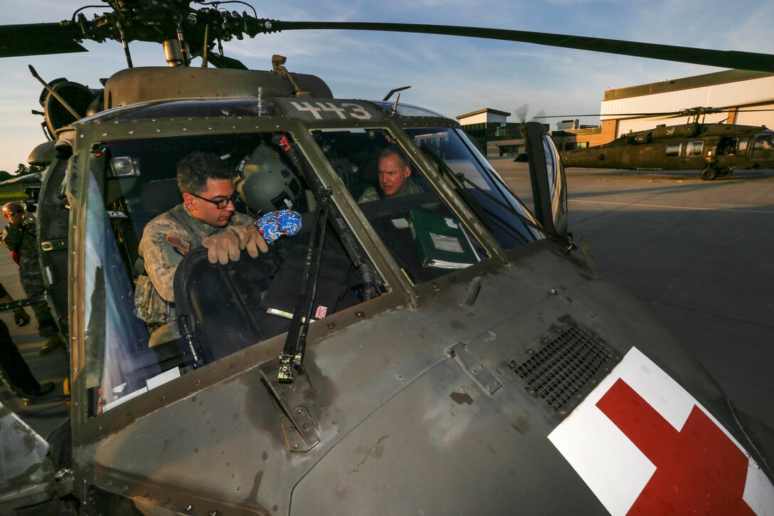 New Jersey Army National Guardsmen perform systems checks inside a UH-60 Black Hawk helicopter at Joint Base McGuire-Dix-Lakehurst, N.J., June 28, 2017. The training was part of New Jersey Task Force One, which provides advanced technical search and rescue capabilities and includes New Jersey National Guard soldiers and airmen, as well as civilians. The soldiers are assigned to the New Jersey Army National Guard’s 1st Battalion, 150th Assault Helicopter Battalion. Air National Guard photo by Master Sgt. Matt Hecht
