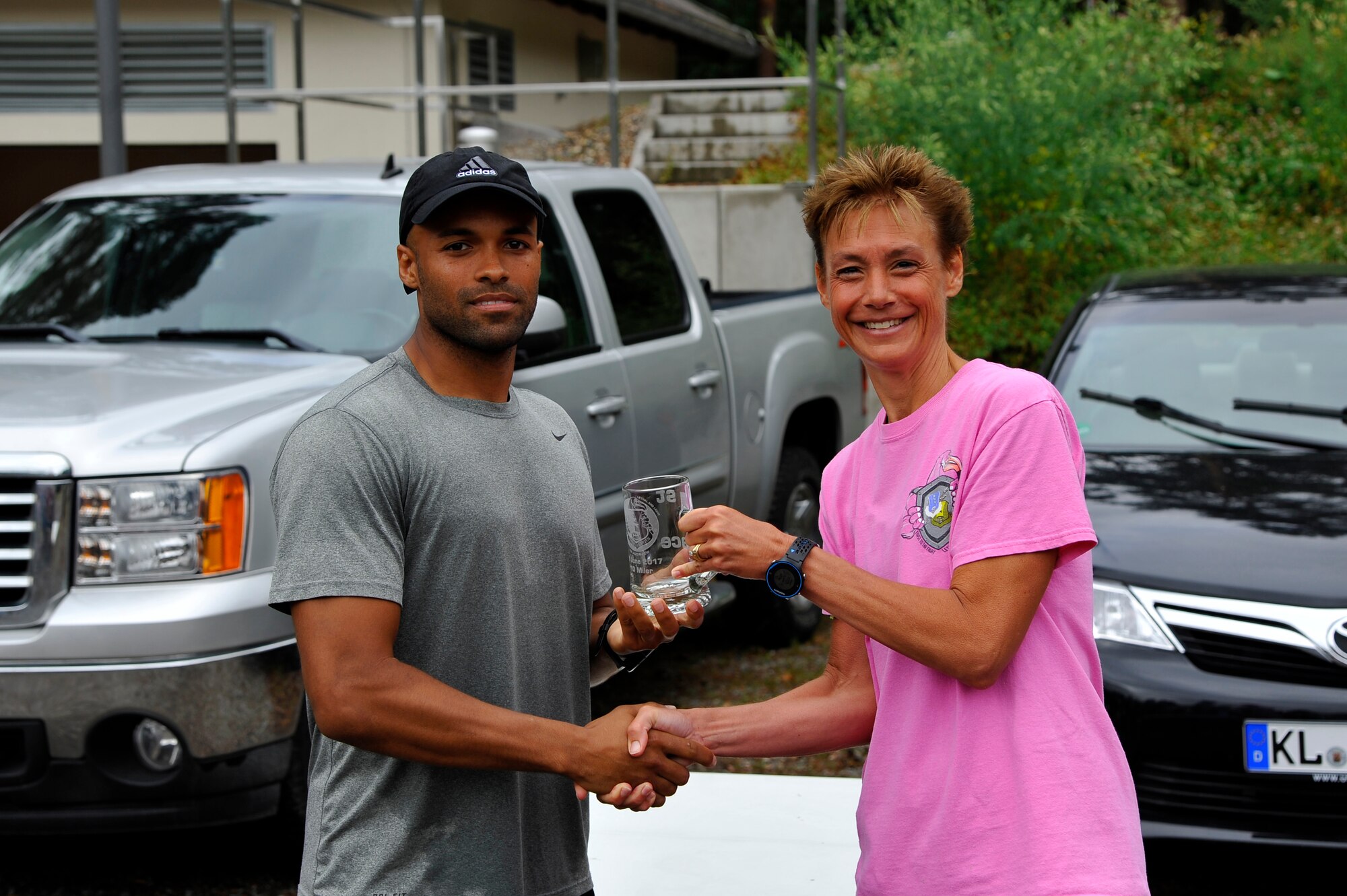 Tech. Sgt. Spencer Wallace, 435th Security Forces Squadron non-commissioned officer in charge of training, receives the first place award from Col. Andra Kniep, 435th Air Ground Operations Wing commander, at the 3rd annual 435th AGOW 10-miler outside the 435th Construction and Training Squadron on Ramstein Air Base, Germany, June 28, 2017. Wallace finished the race with an approximate overall time of 1 hour 9 minutes. (U.S. Air Force photo by Airman 1st Class D. Blake Browning)