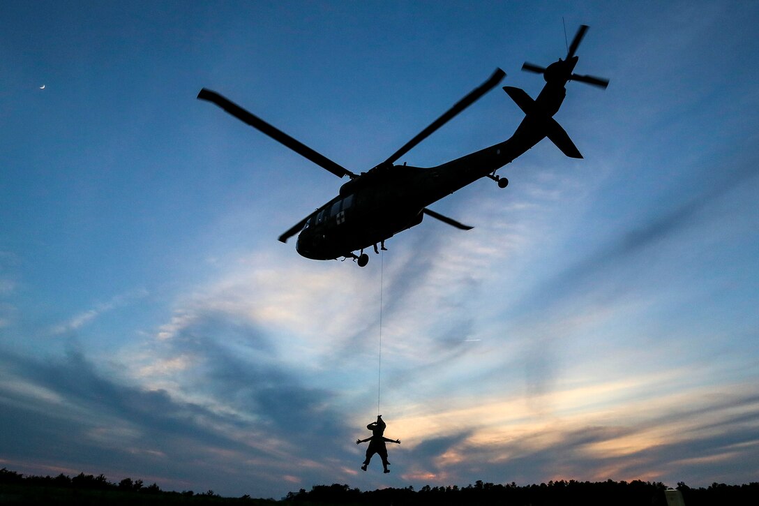 A New Jersey Air National Guardsman descends from a UH-60 Black Hawk helicopter during New Jersey Task Force One training at Joint Base McGuire-Dix-Lakehurst, N.J., June 28, 2017. Air National Guard photo by Master Sgt. Matt Hecht 