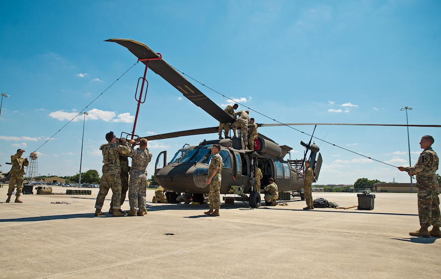 Soldiers from the 1st Calvary Division, 1st Air Combat Brigade, 615th Aviation Support Battalion from Ft. Hood, Texas remove the rotor blades from a UH-60 Black Hawk helicopter June 21, 2017 at Joint Base San Antonio-Lackland, Texas. Operation Silver Galaxy was a five-day training event that featured Airmen training Soldiers how to secure their aircraft for a deployment in the cargo area of a C-5M Super Galaxy. (U.S. Air Force photo by Benjamin Faske)