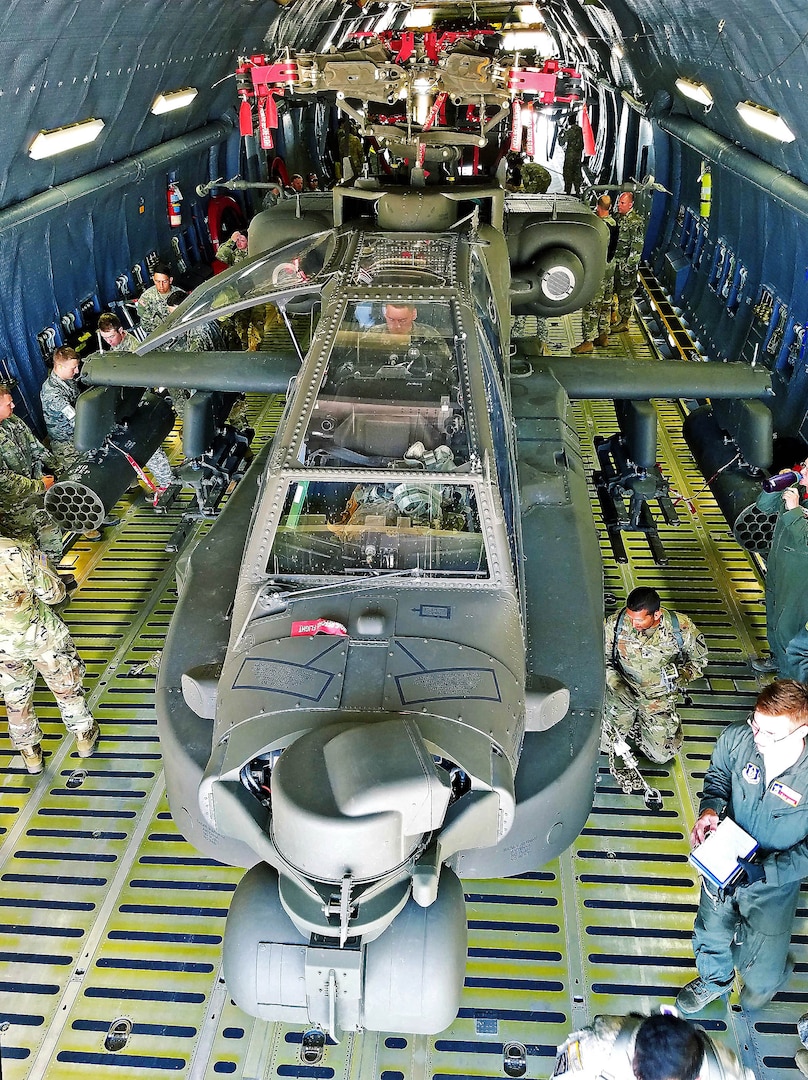 Soldiers from the 1st Calvary Division, 1st Air Combat Brigade, 615th Aviation Support Battalion from Ft. Hood, Texas and Airmen from the 433rd Airlift Wing evaluate uploaded Army helicopters June 23, 2017 at Joint Base San Antonio-Lackland, Texas. The exercise, Operation Silver Galaxy, featured Airmen training Soldiers how to secure their aircraft for a deployment in the cargo area of a C-5M Super Galaxy. (U.S. Air Force photo by Tech. Sgt. Carlos J. Trevino)