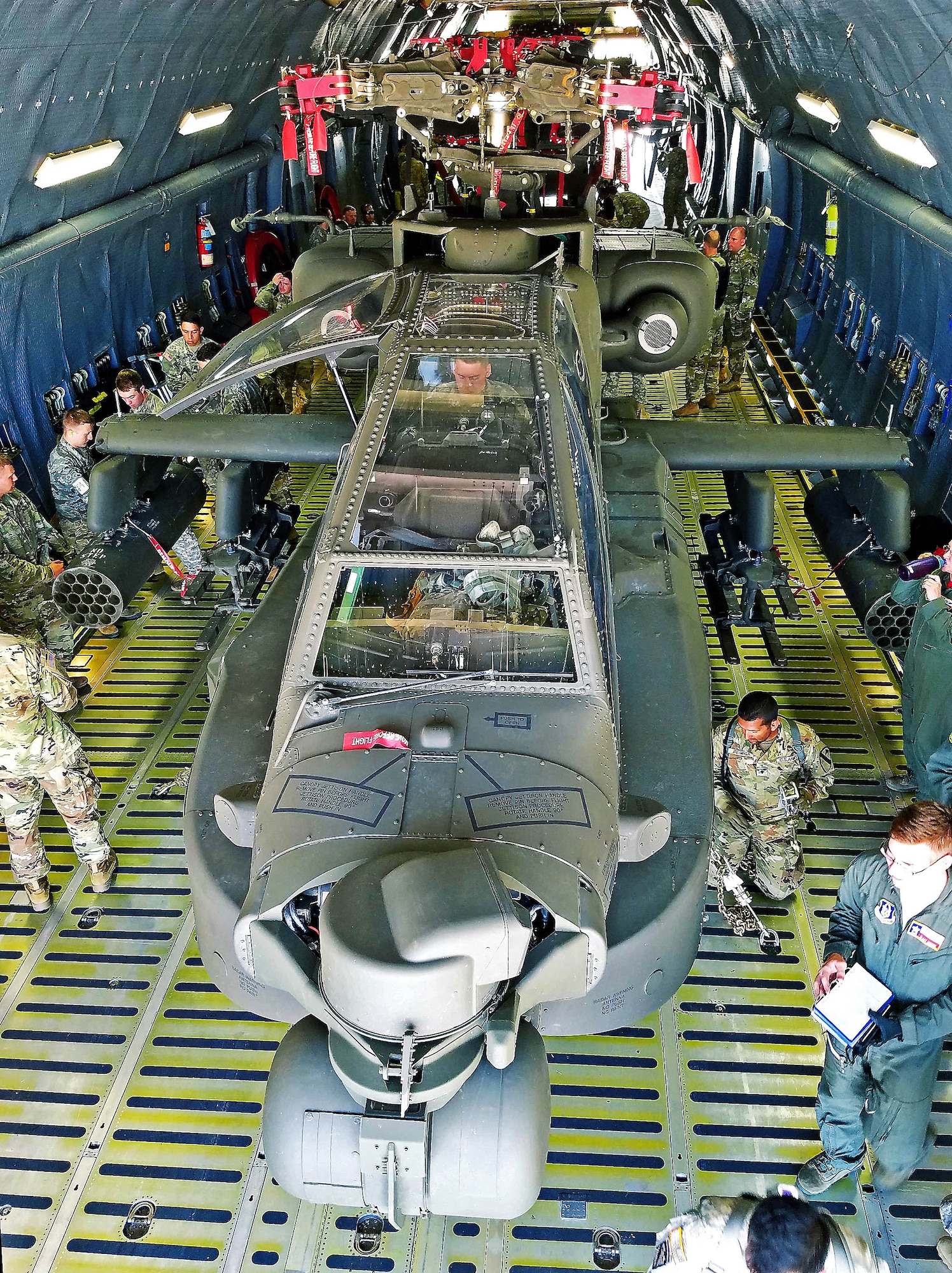 Soldiers from the 1st Calvary Division, 1st Air Combat Brigade, 615th Aviation Support Battalion from Ft. Hood, Texas and Airmen from the 433rd Airlift Wing evaluate uploaded Army helicopters June 23, 2017 at Joint Base San Antonio-Lackland, Texas. The exercise, Operation Silver Galaxy, featured Airmen training Soldiers how to secure their aircraft for a deployment in the cargo area of a C-5M Super Galaxy. (U.S. Air Force photo by Tech. Sgt. Carlos J. Trevino)