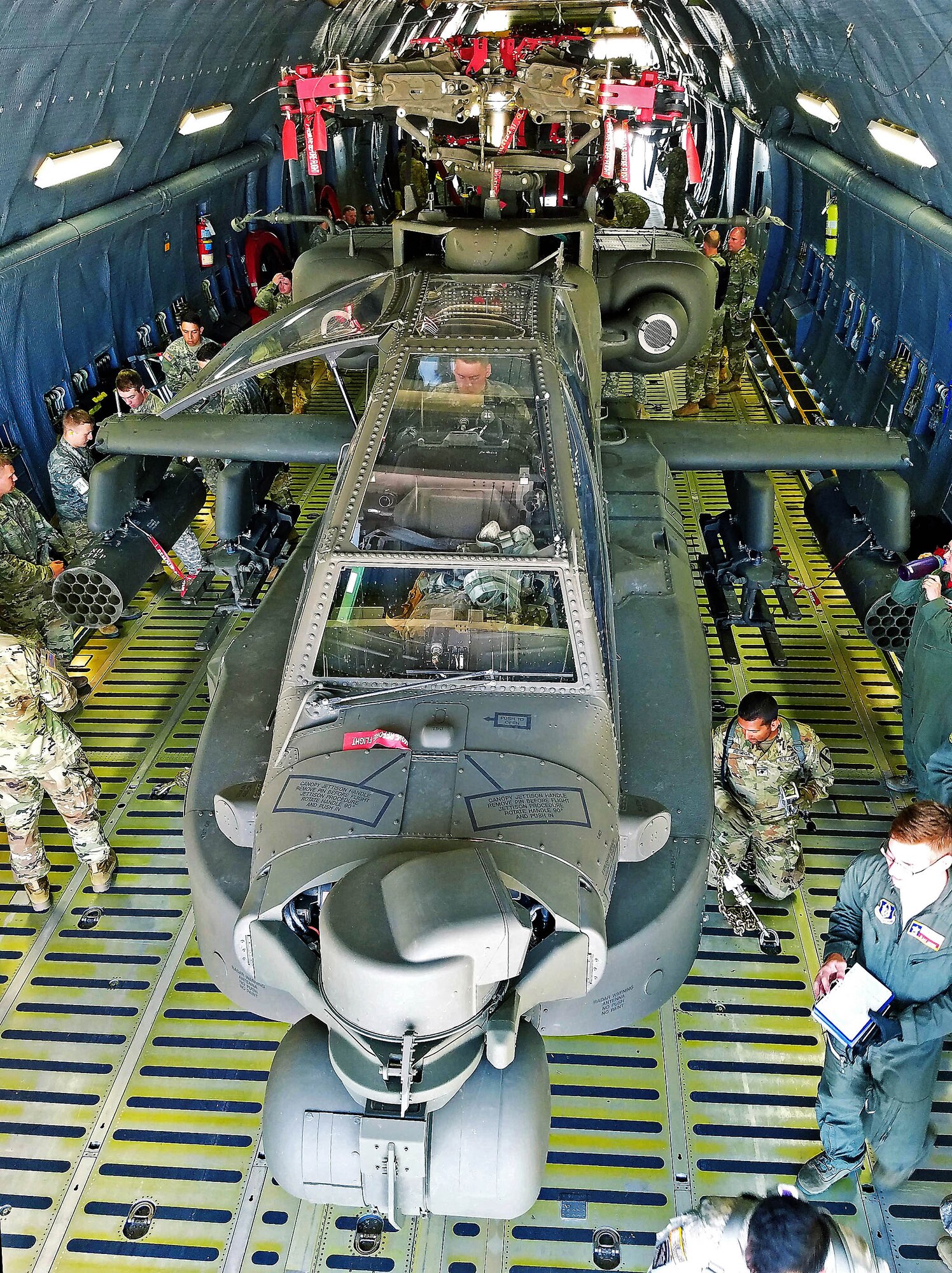 Soldiers from the 1st Calvary Division, 1st Air Combat Brigade, 615th Aviation Support Battalion from Ft. Hood, Texas and Airmen from the 433rd Airlift Wing evaluate uploaded Army helicopters June 23, 2017 at Joint Base San Antonio-Lackland, Texas. The exercise, Operation Silver Galaxy, featured Airmen training Soldiers how to secure their aircraft for a deployment in the cargo area of a C-5M Super Galaxy. (U.S. Air Force photo by Tech. Sgt. Carlos J. Trevino)