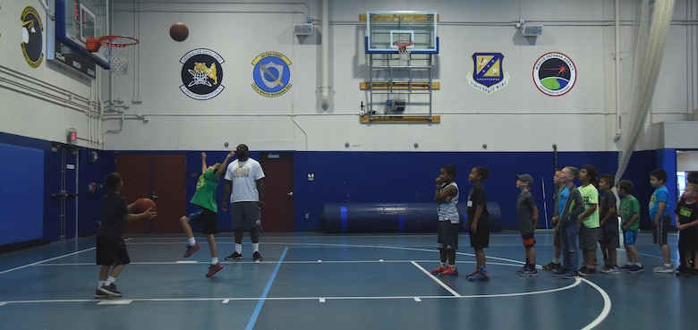 Summer Enrichment Program participants practice shooting baskets at Schriever Air Force Base, Colorado, Wednesday, June 28, 2017. This year marks the second time the base hosted this program, designed to engage the children with several activities during summer. (U.S. Air Force photo/Senior Airman Arielle Vasquez)