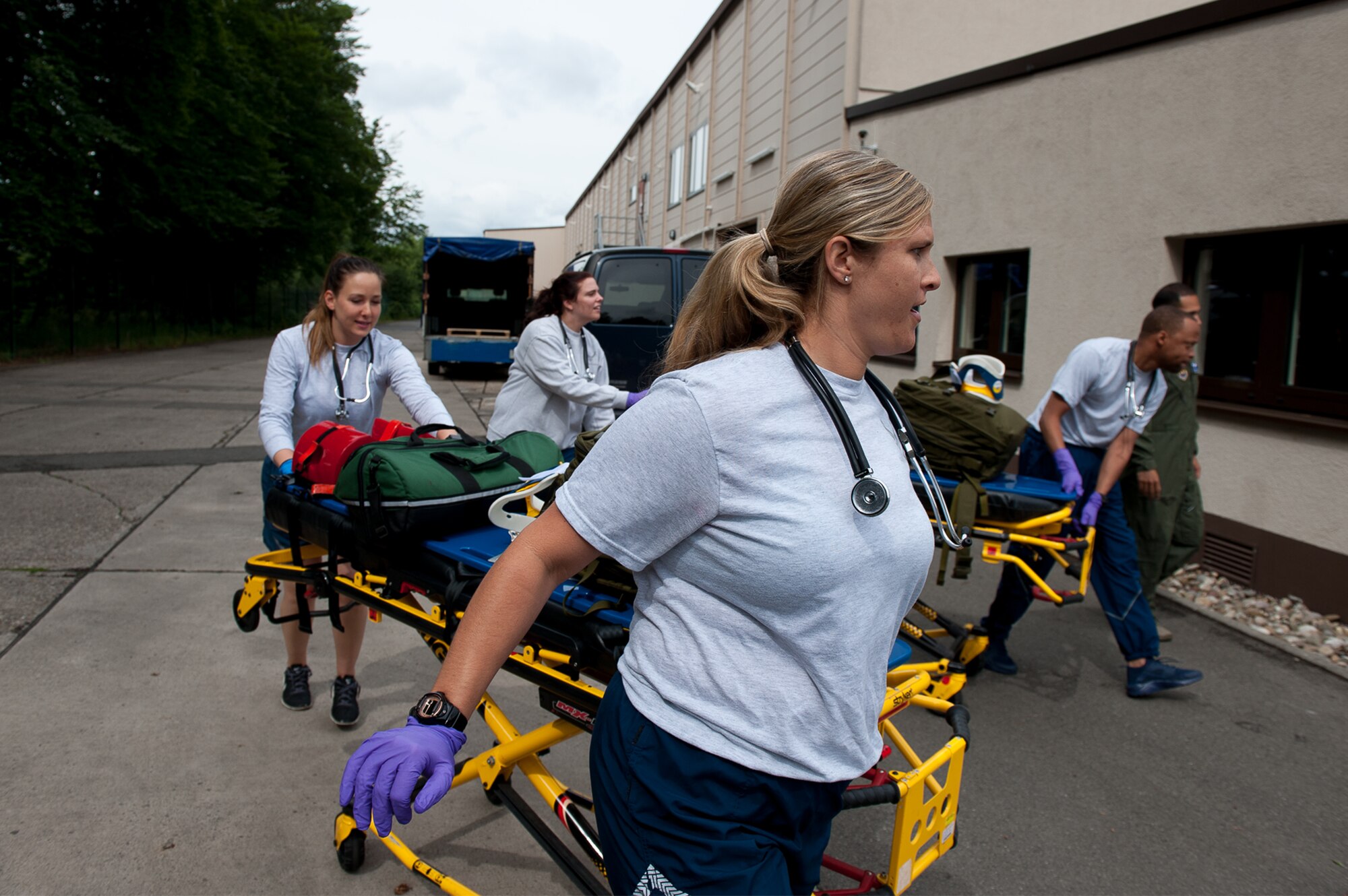 U.S. Air Force Emergency Medical Technicians rush to a scene during a training simulation at the 86th Medical Group Simulation Center on Ramstein Air Base, Germany, June 29, 2017. The students were unaware what the simulation would consist of and had to assess the scenario on the spot like they would in real world. (U.S. Air Force photo by Senior Airman Devin Boyer)