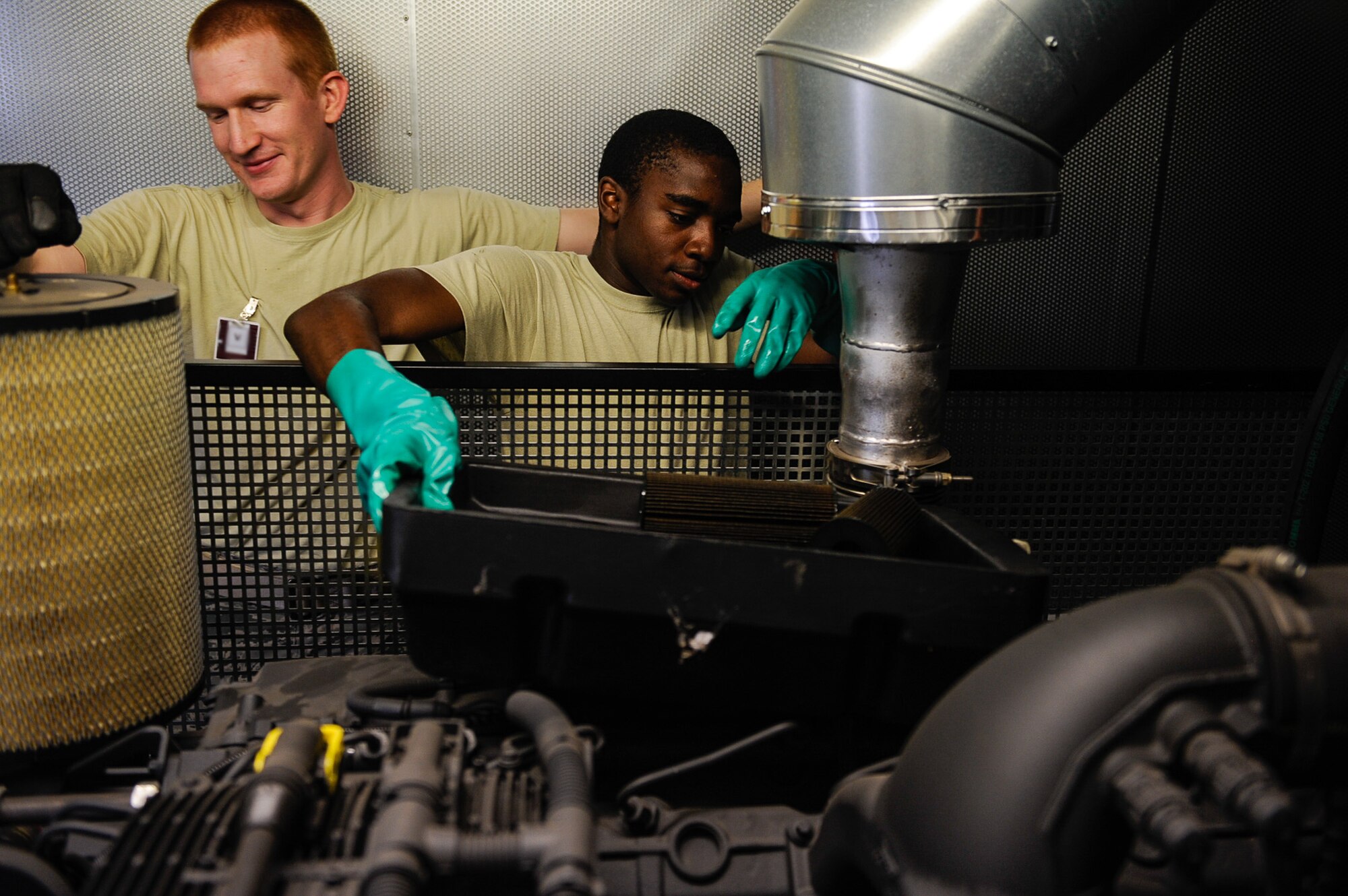 Staff Sgt. Bryce Skawski, 786th Civil Engineer Squadron electrical power production craftsman and Airman 1st Class William Woodside, 786th CES electrical power production apprentice, work alongside one another during a system generator inspection on Ramstein Air Base, Germany, June 27, 2017. CES Airmen perform maintenance on the generator as part of an annual inspection to ensure automated back-up electrical power is provided to mission essential buildings. (U.S. Air Force photo by Airman 1st Class Savannah L. Waters)