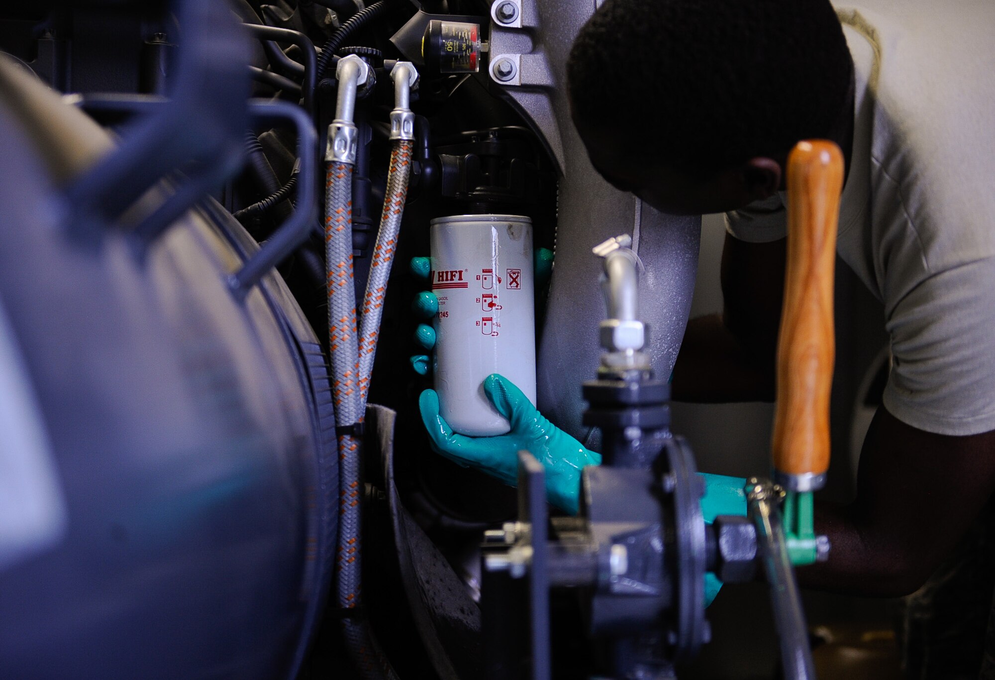 Airman 1st Class William Woodside, 786th Civil Engineer Squadron electrical power production apprentice, installs a new fuel filter on a generator on Ramstein Air Base, Germany, June 27, 2017. Electrical power production technicians perform regular maintenance inspections and test more than 120 emergency power systems on Ramstein. (U.S. Air Force photo by Airman 1st Class Savannah L. Waters)