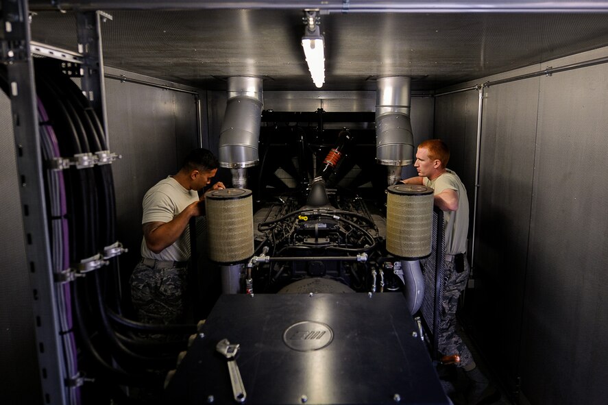 Staff Sgt. Justin Tayamen and Staff Sgt. Bryce Skawski, 786th Civil Engineer Squadron electrical power production craftsmen, discuss plans for a generator preventative maintenance inspection on Ramstein Air Base, Germany, June 27, 2017. The generator system’s equipment provides automated back-up electrical power to Ramstein’s most critical facilities. (U.S. Air Force photo by Airman 1st Class Savannah L. Waters)