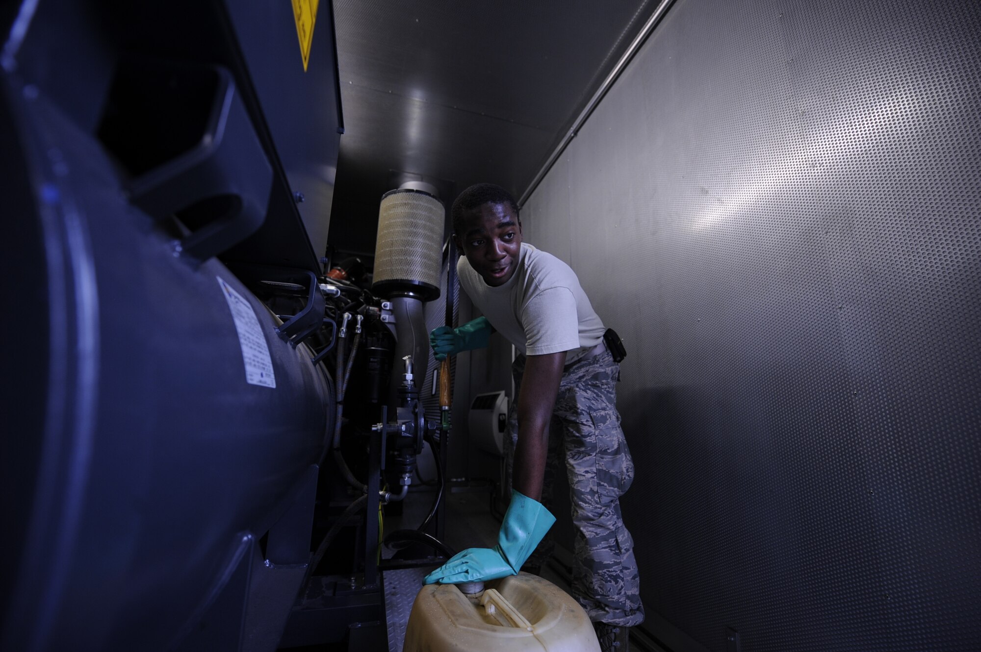 Airman 1st Class William Woodside, 786th Civil Engineer Squadron electrical power production apprentice, pumps used oil out of a generator on Ramstein Air Base, Germany, June 27, 2017. Pumping used oil from a generator was part of an annual inspection to ensure automated back-up electrical power is provided to mission essential buildings. (U.S. Air Force photo by Airman 1st Class Savannah L. Waters)
