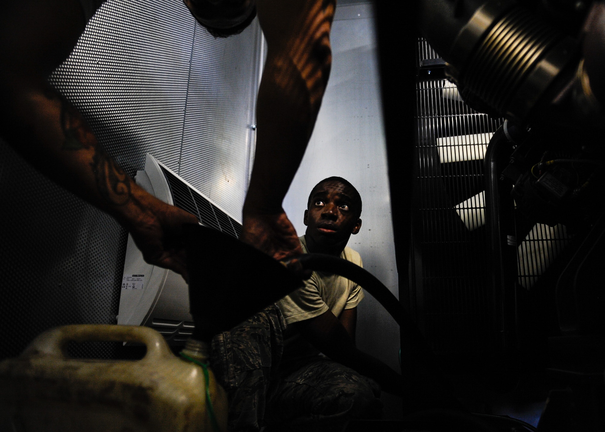 Airman 1st Class William Woodside, 786th Civil Engineer Squadron electrical power production apprentice, drains coolant out of a generator system on Ramstein Air Base, Germany, June 27, 2017. The preventative maintenance provided fresh fluids to prevent the system from malfunctioning during a real-world power outage and mitigates mission stoppage due to loss of commercial power. (U.S. Air Force photo by Airman 1st Class Savannah L. Waters)