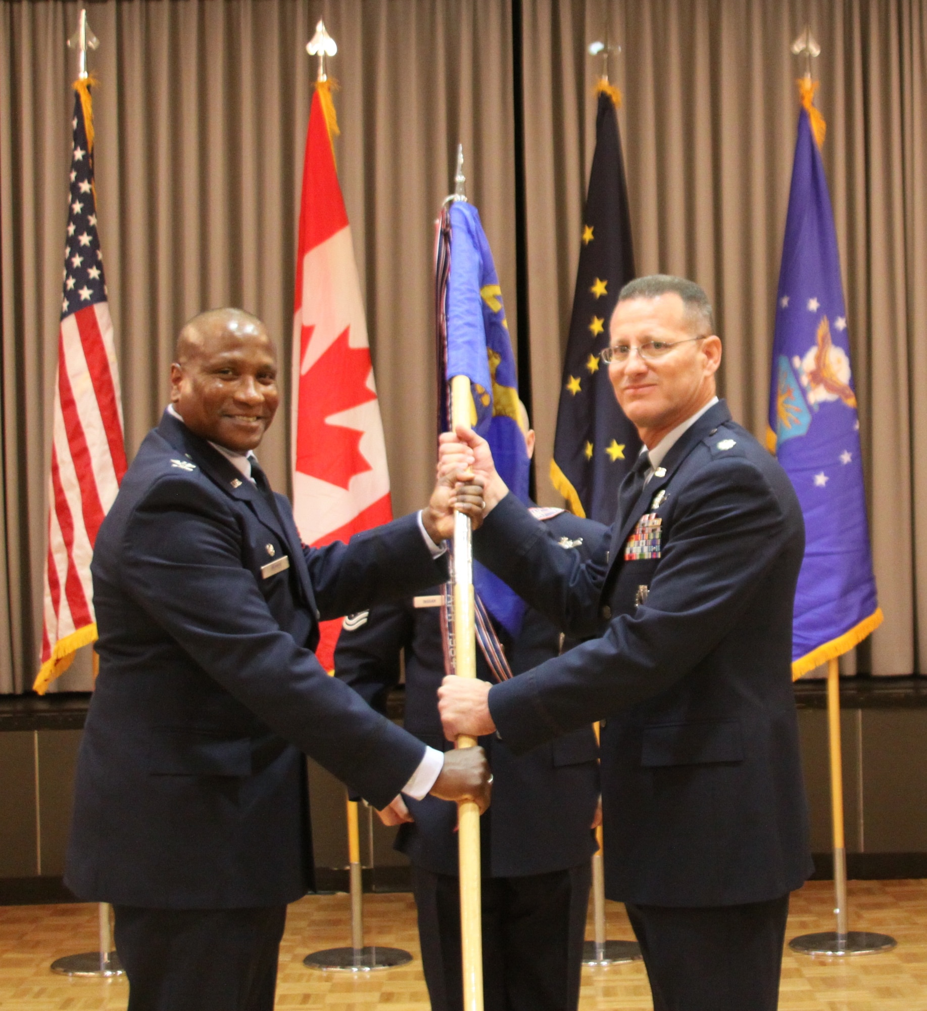 CLEAR AIR FORCE STATION, Alaska – Col. Devin Pepper, 21st Operations Group commander, passes the 13th Space Warning Squadron guidon to Lt. Col. Joel Lane during a change of command ceremony, June 13, 2017, at Clear Air Force Station, Alaska.   