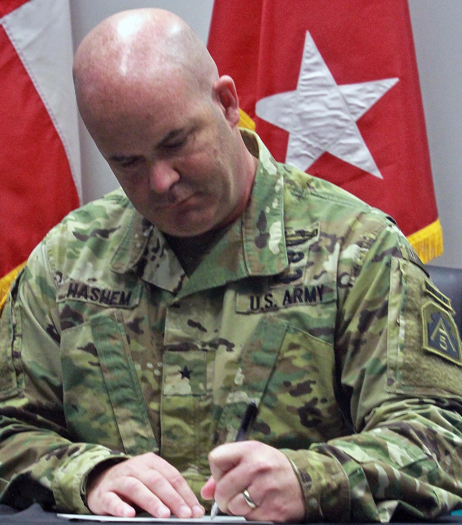 Brig. Gen. John Hashem, deputy commanding general-support and director of Army Reserve Engagement Cell, or AREC, at U.S. Army North (Fifth Army), signs the Memorandum of Understanding at Laredo Community College’s De La Garza building in Laredo, Texas, June 27 during the Innovative Readiness Training, or IRT, Mission. This memorandum signifies the commitment of the military and the surrounding communities for future IRT missions. 