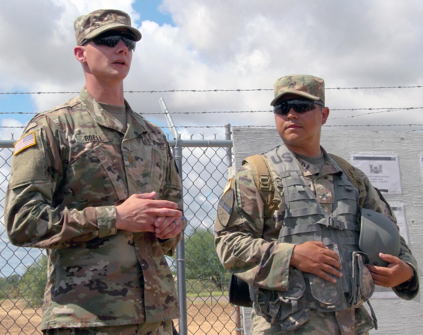 Second Lt. Michael Roell (left) and Sgt. Reuben Aleman, engineers with U.S. Army Reserve 312th Engineer Company, explain their project board during a briefing to distinguished visitors for the Innovative Readiness Training, or IRT, mission June 27 in Laredo, Texas. Both engineers were tasked with road improvement during the IRT mission as part of their two-week training.  
