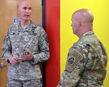 Maj. Edward King (left), medical site officer-in-charge for Larga Vista Community Center, briefs Brig. Gen. John Hashem (right), deputy commanding general-support and director of the Army Reserve Engagement Cell, or AREC, at U.S. Army North (Fifth Army), about the various aspects of medical assistance his unit is providing the community in Laredo, Texas, June 27. At this community, residents received dental exams, health screenings and dietary information. 