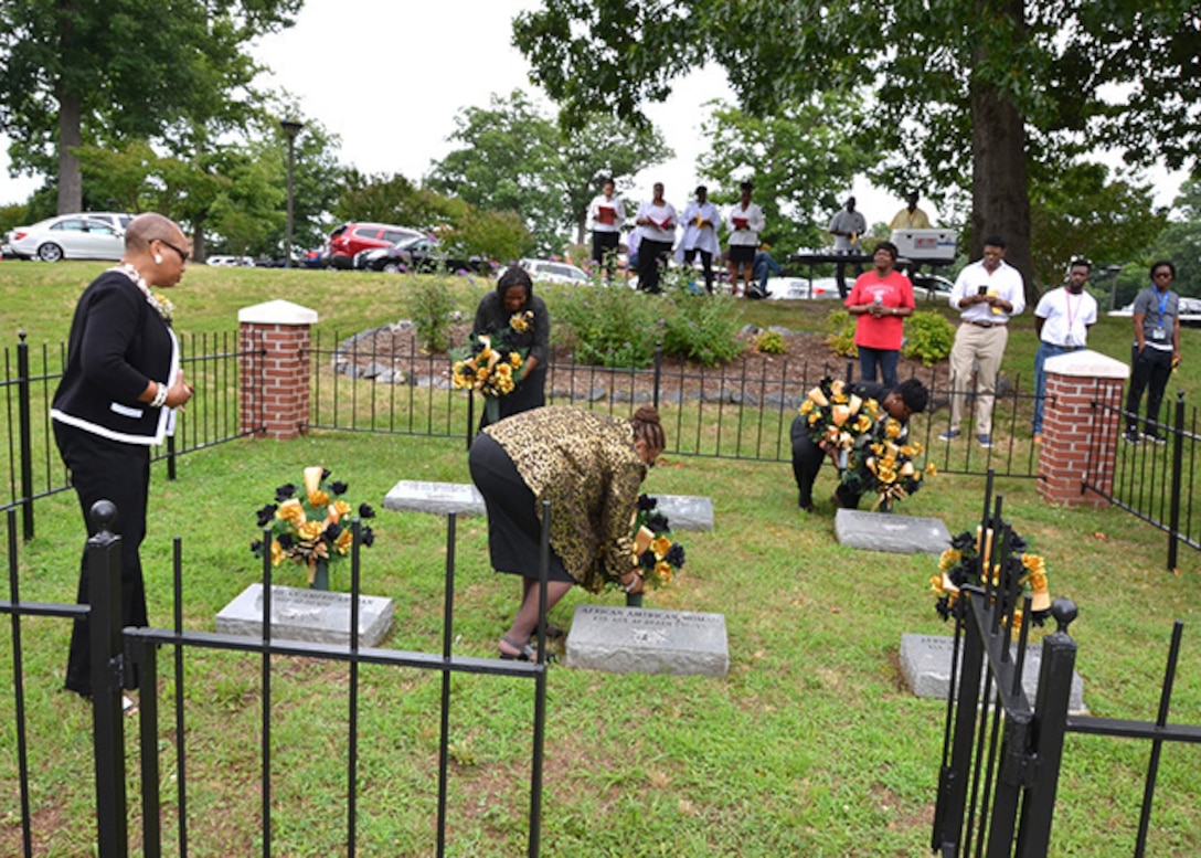 Defense Logistics Agency Aviation’s Bellwood Chapter of Blacks in Government members place flowers on the graves of unknown African-Americans during the Juneteenth Observance celebrated June 23, 2017 on Defense Supply Center Richmond, Virginia. 