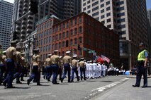 Marines and Sailors march through the streets during the Sail Boston 2017 street parade held in Boston, Mass., June 19, 2017. Marines, sailors and various participants of Sail Boston paraded the streets in celebration of the occasion. Sail Boston brought together military members and sailing enthusiasts from around the world, welcoming them to sail the Boston harbor, interact with the community, and enjoy the sights of the city. (U.S. Marine Corps photo by Cpl. Mackenzie Gibson/Released)