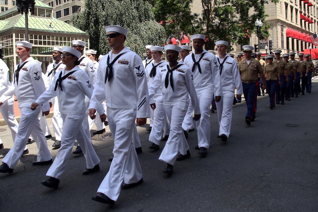 Marines and Sailors march through the streets during the Sail Boston 2017 street parade held in Boston, Mass., June 19, 2017. Marines, Sailors and various participants of Sail Boston paraded the streets in celebration of the occasion. Sail Boston brought together military members and sailing enthusiasts from around the world, welcoming them to sail the Boston harbor, interact with the community, and enjoy the sights of the city. (U.S. Marine Corps photo by Cpl. Mackenzie Gibson/Released) 