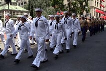 Marines and Sailors march through the streets during the Sail Boston 2017 street parade held in Boston, Mass., June 19, 2017. Marines, Sailors and various participants of Sail Boston paraded the streets in celebration of the occasion. Sail Boston brought together military members and sailing enthusiasts from around the world, welcoming them to sail the Boston harbor, interact with the community, and enjoy the sights of the city. (U.S. Marine Corps photo by Cpl. Mackenzie Gibson/Released) 