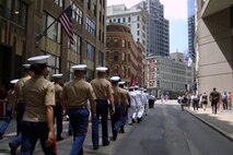 Marines and Sailors march through the streets during the Sail Boston 2017 street parade held in Boston, Mass., June 19, 2017. Marines, Sailors and various participants of Sail Boston paraded the streets in celebration of the occasion. Sail Boston brought together military members and sailing enthusiasts from around the world, welcoming them to sail the Boston harbor, interact with the community, and enjoy the sights of the city. (U.S. Marine Corps photo by Cpl. Mackenzie Gibson/Released) 